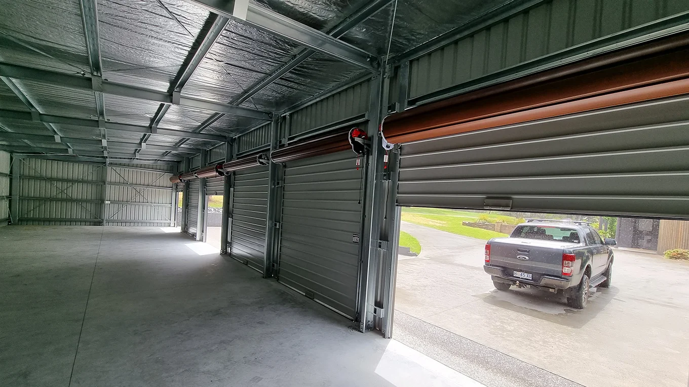 Multi-bay garage with multiple roller doors.
