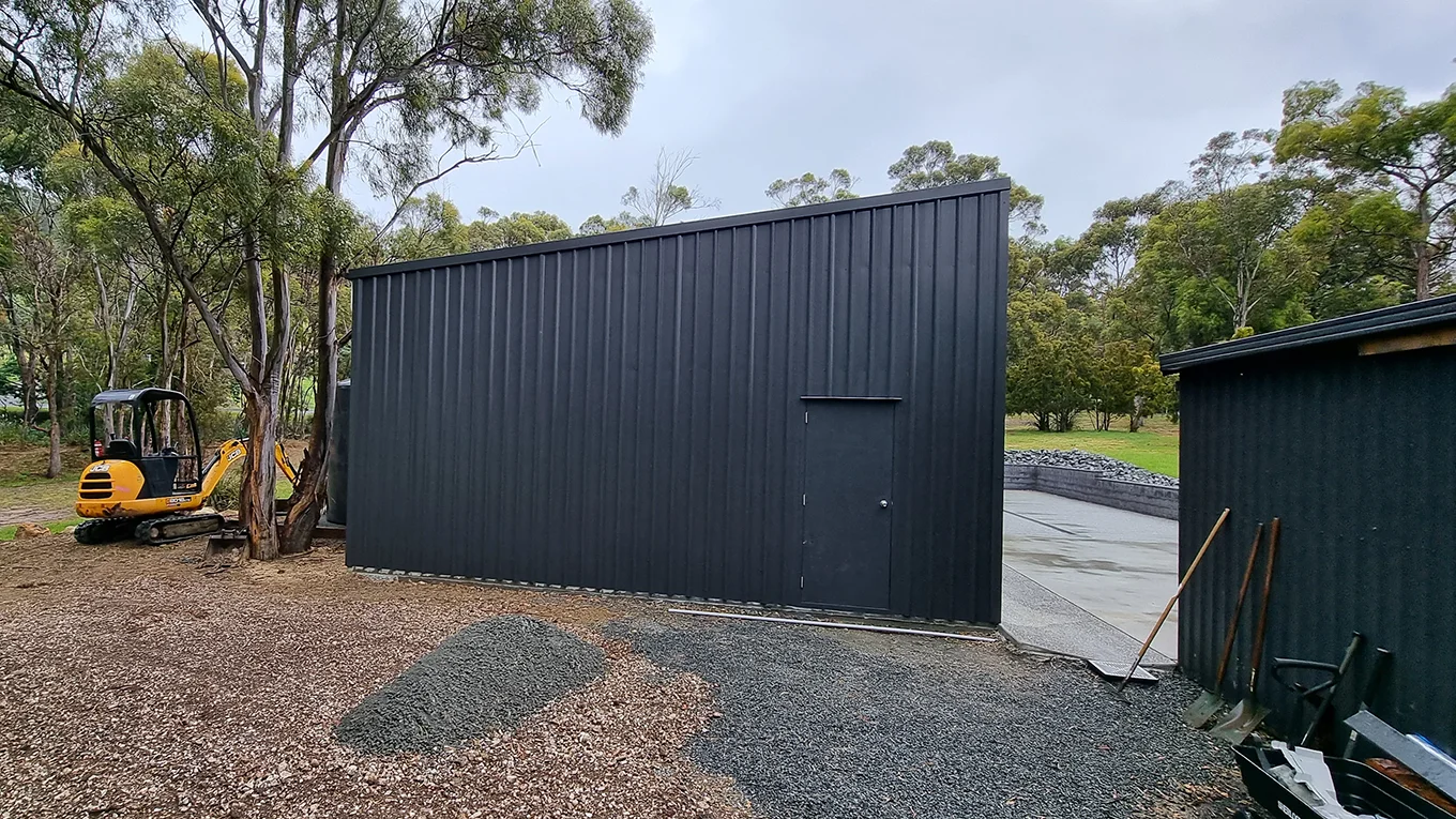 Side view of a compact Monument shed with personal access door.