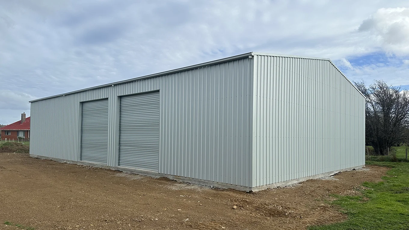 Farm shed with dual roller doors and gable roof.