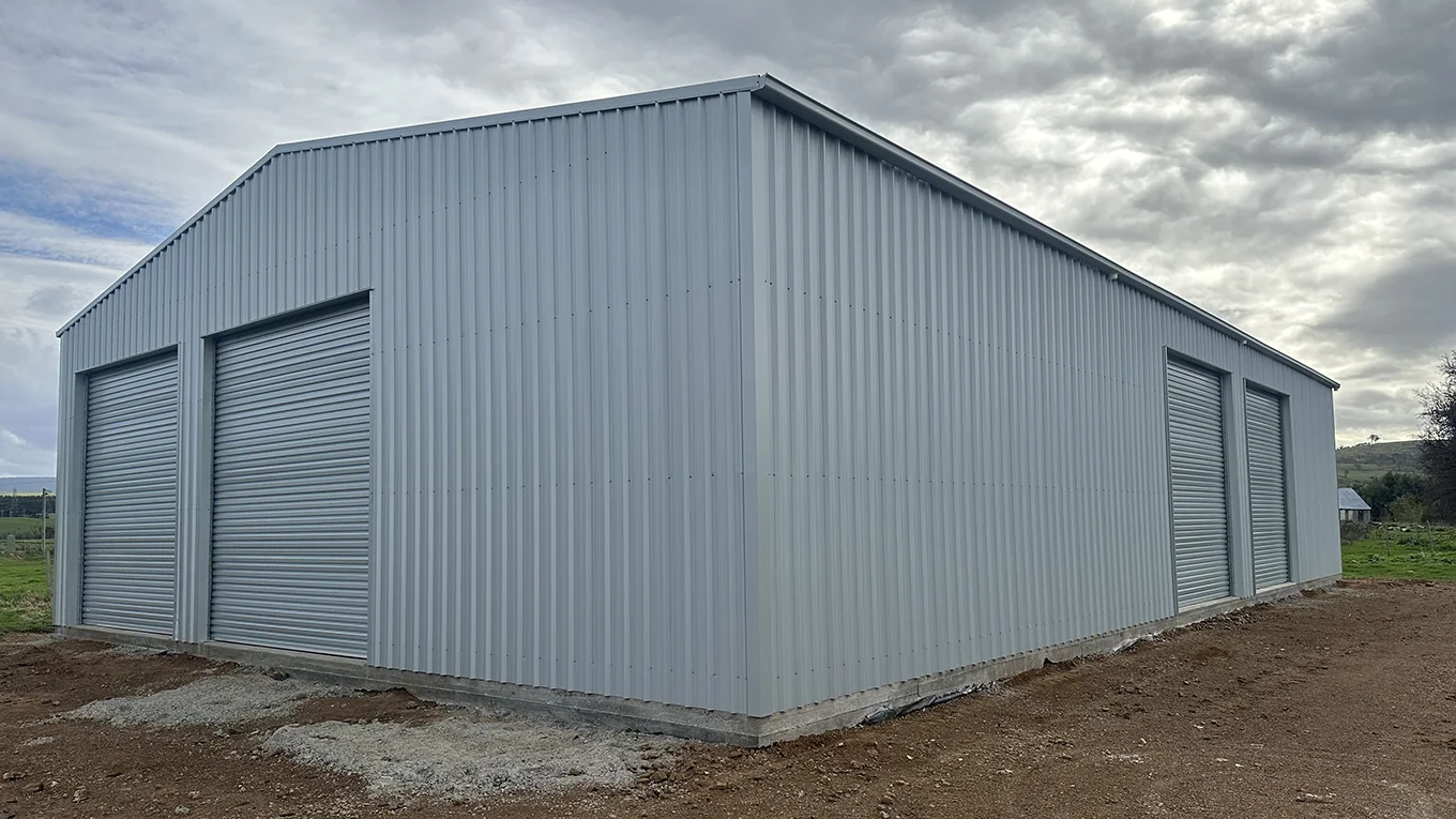 Machinery farm shed with four roller doors.