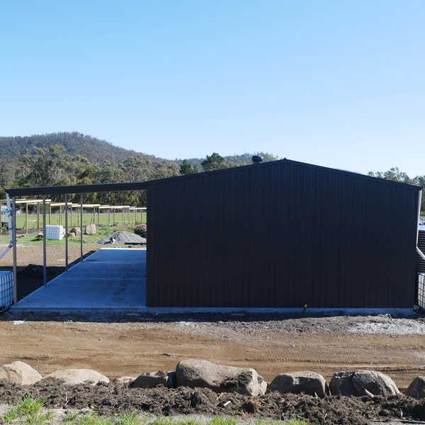Rural Shed clad in Monument with awning for machinery built in Gatton