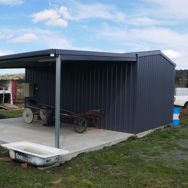 small shed with awning covered in Deep Ocean cladding