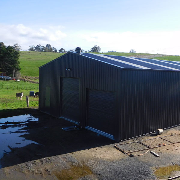 shed built out of Colorbond Monument with 2 roller doors.