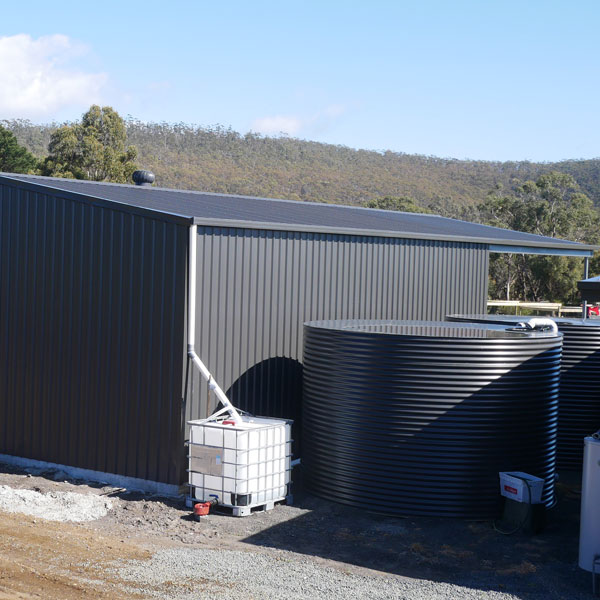 Colorbond shed built in Tasmania with matching watertank in the colour Monument