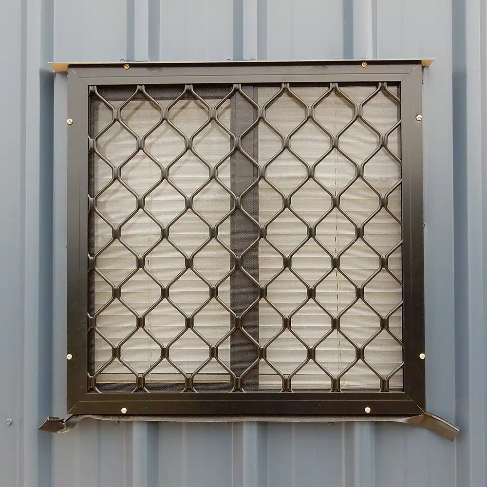 Close up of an aluminium window with a mesh screen.