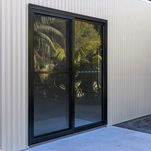 Glass sliding door installed in a Classic Cream shed.