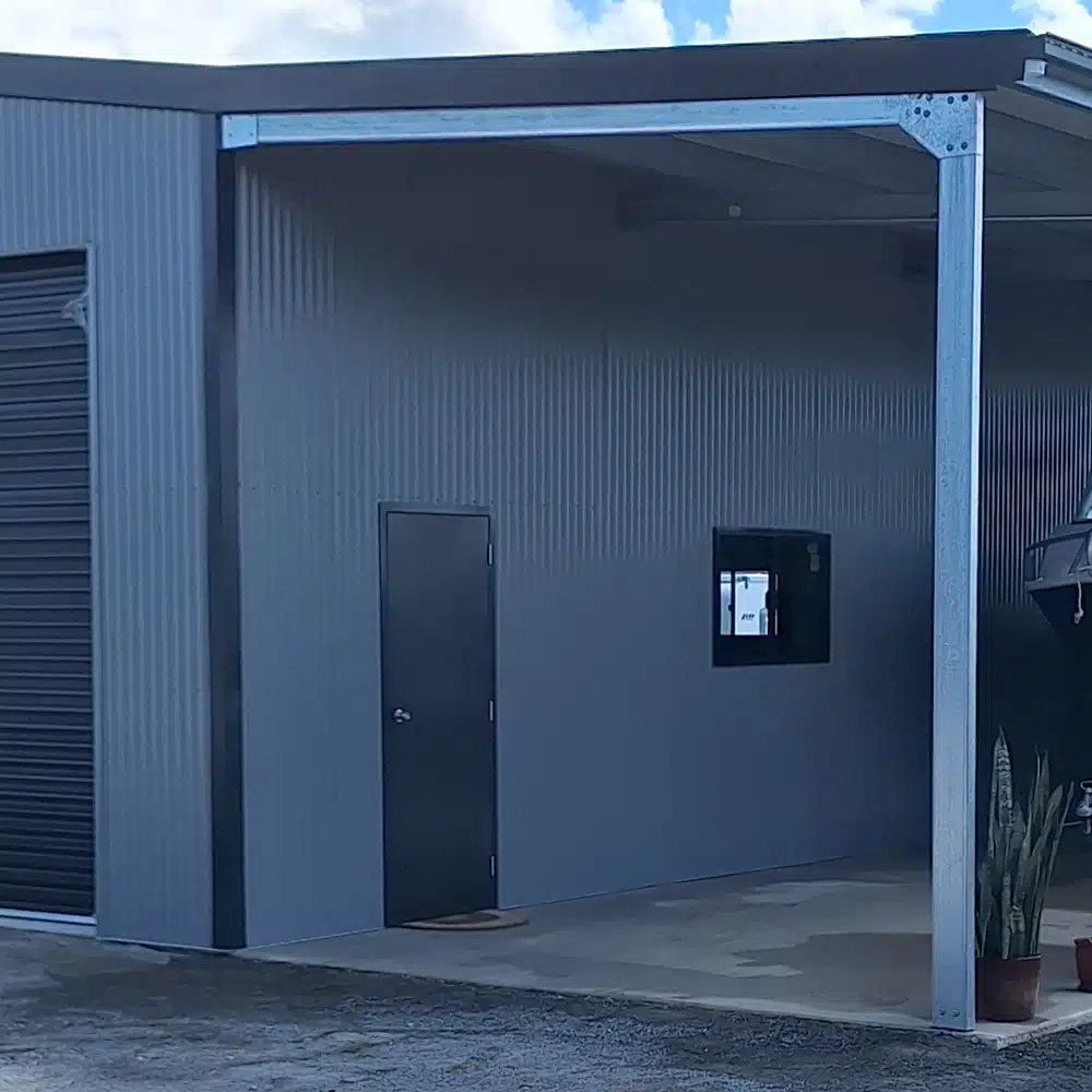 Window and personal access door under the awning of a Colorbond shed.