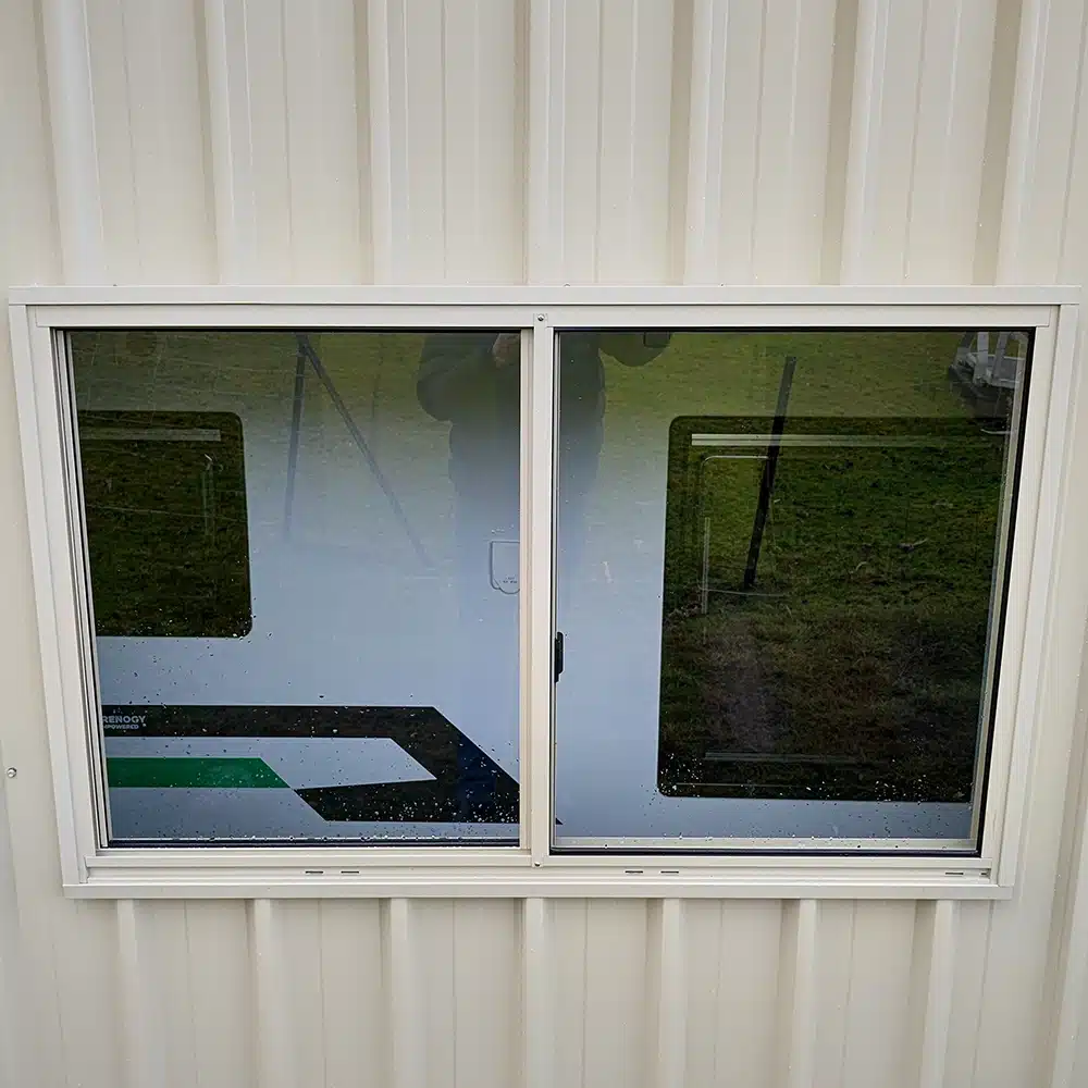 Up close photo of a shed window install in the side of a True Blue Sheds garage.