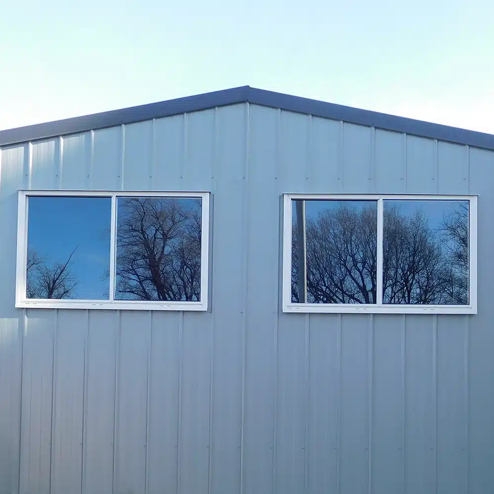 Small Colorbond shed with two windows in the gable end.